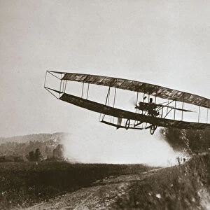 American aviator Glenn Curtiss making the first heavier-than-air flight in his June Bug, 1908