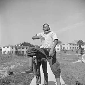 Boys playing leap frog near the project, Frederick Douglass housing project, Anacostia, D. C. 1942. Creator: Gordon Parks