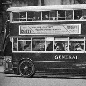 A double-decker bus standing outside the Law Courts, London, 1926-1927