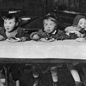 East End children being fed by a charitable organisation, London, 1926-1927