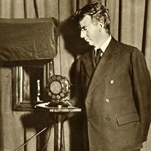 John Logie Baird watching the first play to be televised, 14 July 1930, (1935). Creator: Unknown
