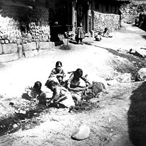 Korean children in the street, Nam San, Korea, 1900
