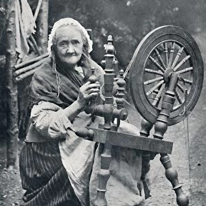 An old Irish woman at her spinning-wheel, 1912. Artist: W Lawrence