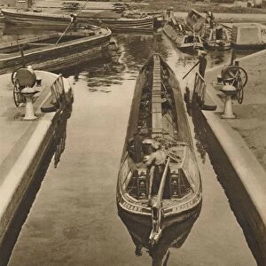 Pushing a Monkey Boat Through The Lock at Brentford, c1935. Creator: Unknown