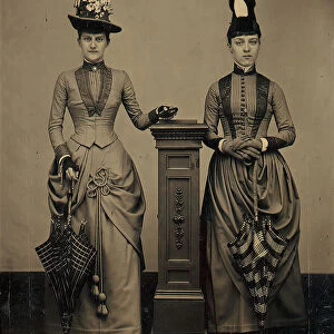 Studio Portrait of Two Women Holding Folded Parasols, ca. 1885. Creator: Unknown
