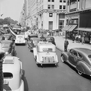 Traffic on Fifth Avenue approaching 57th Street on a summer afternoon, New York City, 1939. Creator: Dorothea Lange