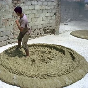 Treading clay for pottery in Tunisia. Artist: CM Dixon