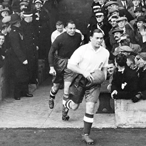 Sam Barkas, captain of the England Football Team, leads them out to play Wales at Middlesborough 1937