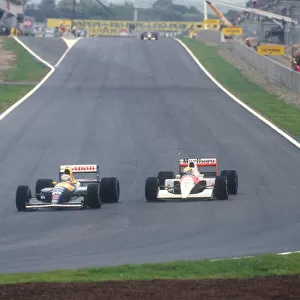 1991 Spanish Grand Prix. Barcelona, Spain. 27-29 September 1991. Nigel Mansell (Williams FW14 Renault) overtakes Ayrton Senna (McLaren MP4 / 6 Honda) into turn 1