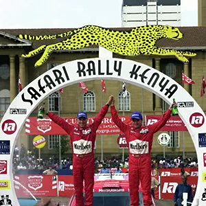 2001 World Rally Championship. Nairobi, Kenya. July 20-22, 2001 Tommi Makinen and Risto Mannisenmaki celebrate their victory on the podium. Photo: Ralph Hardwick/LAT