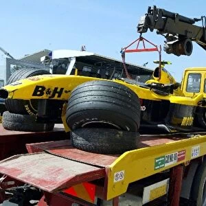 Formula One World Championship: The Jordan Ford EJ14 of Timo Glock is returned to the pits after crashing during practice