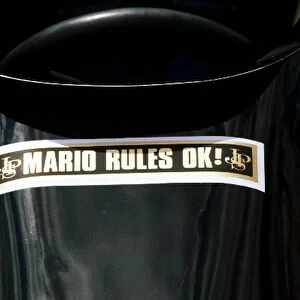 Formula One World Championship: The Lotus 78 of Mario Andretti, who retired from the race on lap 63 with a blown engine, carries a message of