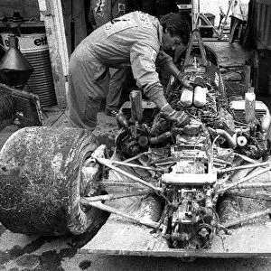 Formula One World Championship: A mechanic surveys the damage to the Ligier JS27 of Jacques Laffite after suffering a major fire when the fuel