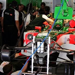Formula One World Championship: Mechanics work on the Jaguar R5 in the pits