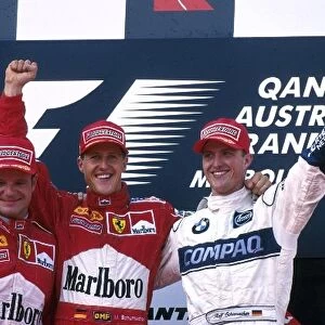 Formula One World Championship: Michael Schumacher Ferrari F1 2000 wins with team mate Rubens Barrichello Ferrari F1 2000, 2nd place on left