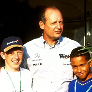 Formula One World Championship: Ron Dennis McLaren team principal with Lewis Hamilton, right and Andrew Delahunty from Kartings Champions of