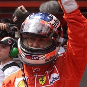 Michael Schumacher celebrates getting pole position