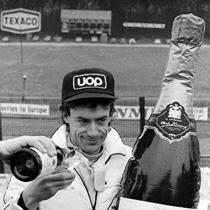 Non-Championship Formula One: Pole sitter Tom Pryce Shadow, receives his traditional champagne after claiming pole position. He went on to take his first