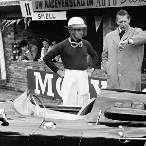 Zandvoort, Holland. 25 May 1958: Team Owner Rob Walker checks the time with his driver Maurice Trintignant, Cooper T45-Climax, 9th position, portrait