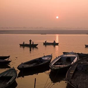 Boats On Ganges River At Sunset; Varanasi, India