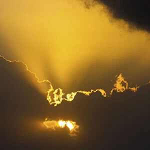 Close Up Of The Sun Coming Through Clouds With Rays Beaming Up At Sunrise; Akumal, Quintana Roo, Mexico