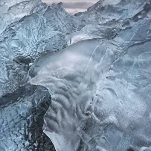 A close-up view of glacial ice strewn across a coastal beach; iceland