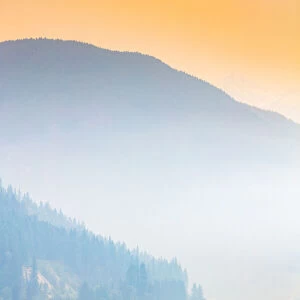 Fog over a mountain lake at sunrise