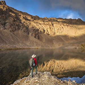 Male Hiker Enjoying The View Of Hidden Lake, Chugach State Park, Southcentral Alaska