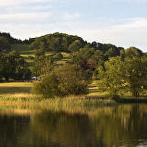 Panoramic Landscape Reflected In A Tranquil Lake; Lake District, Cumbria, England