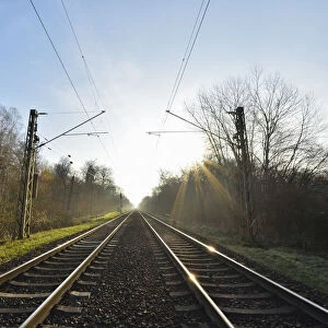 Railroad tracks with Sun, Arheiligen, Darmstadt, Hesse, Germany