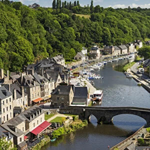 Treed Valley Riverside Town, Stone Bridge And Boats In The Harbour With Blue Sky And Clouds; Dinan, Brittany, France