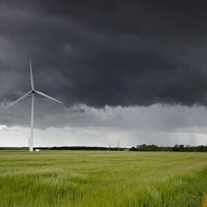 Wind turbine and storm clouds; Northumberland england