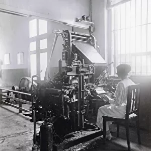 Woman working at a type-setting machine in the printworks of the Deli Courant in Medan, Indonesia. The Deli Courant, founded in 1885, was the first Dutch language newspaper in Medan. This picture dates from circa 1920