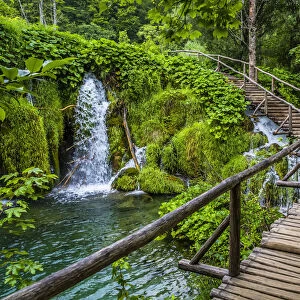 Wooden footbridge crossing over the waterfalls at the Plitvice Lakes National Park, Croatia