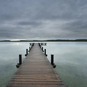 Wooden jetty on Lake Worthsee, Fuenfseenland, Upper Bavaria, Germany