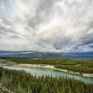 Yukon River with a storm passing overhead while flowing through Whitehorse; Whitehorse, Yukon, Canada