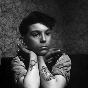 14-year-old Arthur Waterworth of Droylsden shows off his tattooed forearms