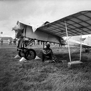 27 year old Gina McEvoy of Berkshire, sheltering from the rain under the wing of a 1911