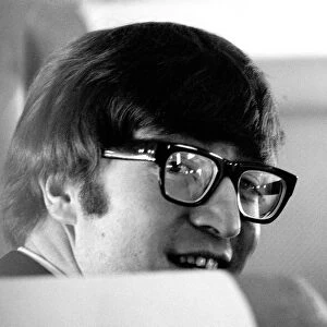 7 February 1964 John Lennon with wife Cynthia on the aircraft to New York