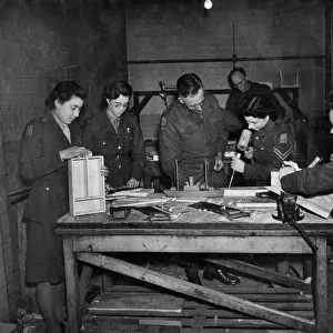 A. T. S. furniture factory. Lt. Archard (Centre) teaching his class the art of woodworking