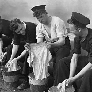 Able seamen aboard HMS Albion seen here doing the washing. 18th August 1942
