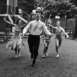 Actor Bernard Bresslaw being chased by three women July 1958
