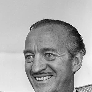 Actor David Niven relaxes in his suite at the Connaught Hotel, London