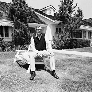 Actor Michael Caine relaxes outside his home in California, USA. 15th April 1984