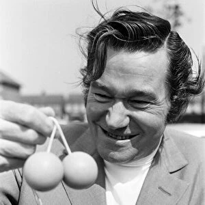 Actor, Reg Varney photo-call playing with new game Ker Knockers, at Wembley