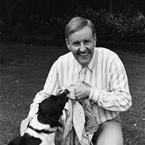 Actor Richard Briers seen here in the back garden of his West London home with his dog