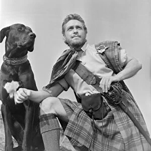 Actor Richard Todd with a black labrador in his role as Rob Roy in the film Rob Roy