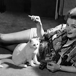 Actress Erica Rogers seen with her cat Piewacket at her Hampstead flat