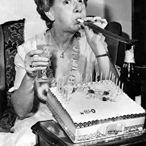 Actress Jean Alexander gets the party spirit-with champagne, cake and key of the door