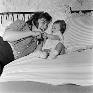 Actress Nanette Newman with her baby daughter Sarah Kate at their home in Virginia Water